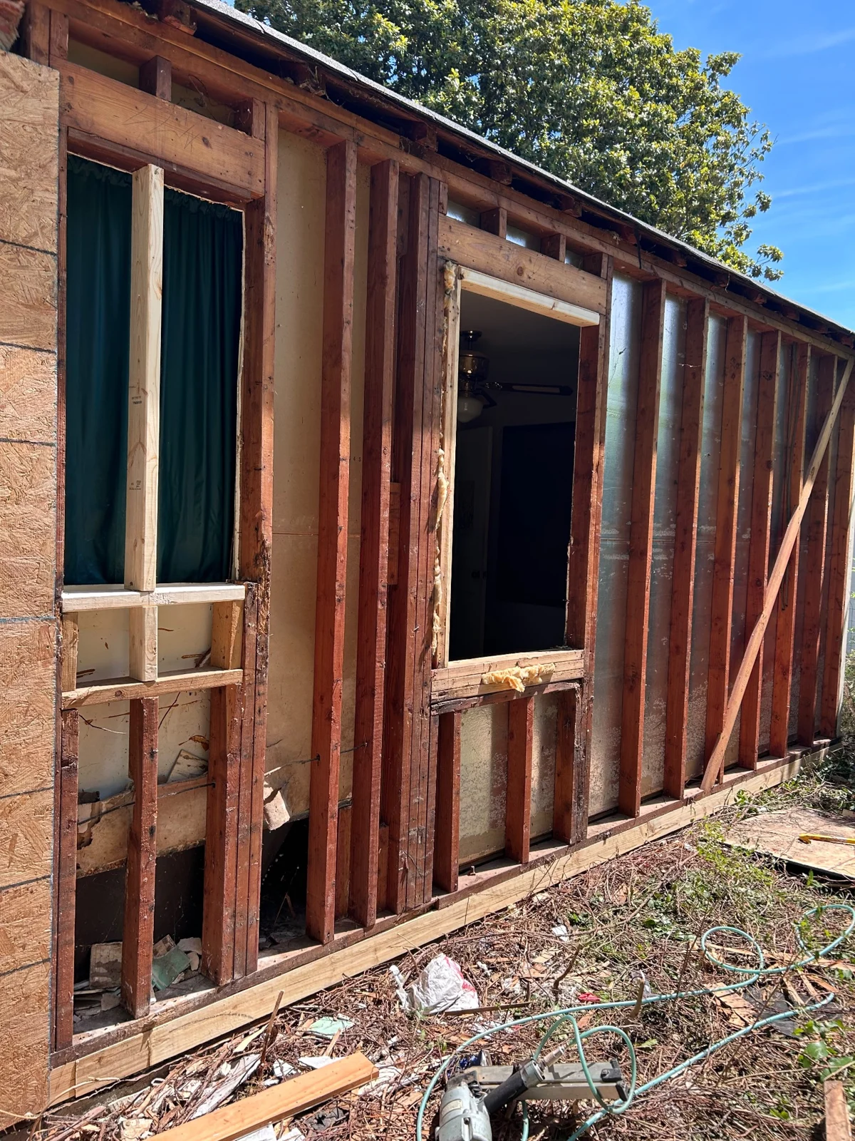 Exposed wood framing during the exterior repair